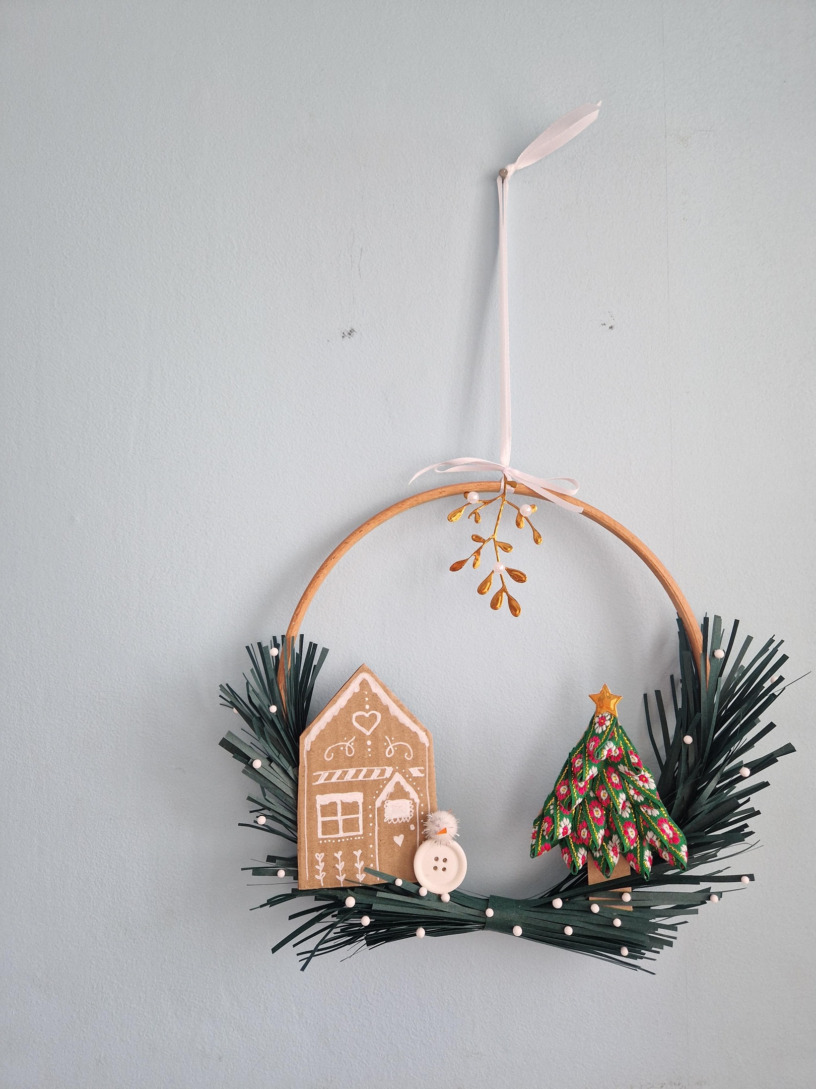 Christmas wreath made from waste materials at a sustainable craft workshop