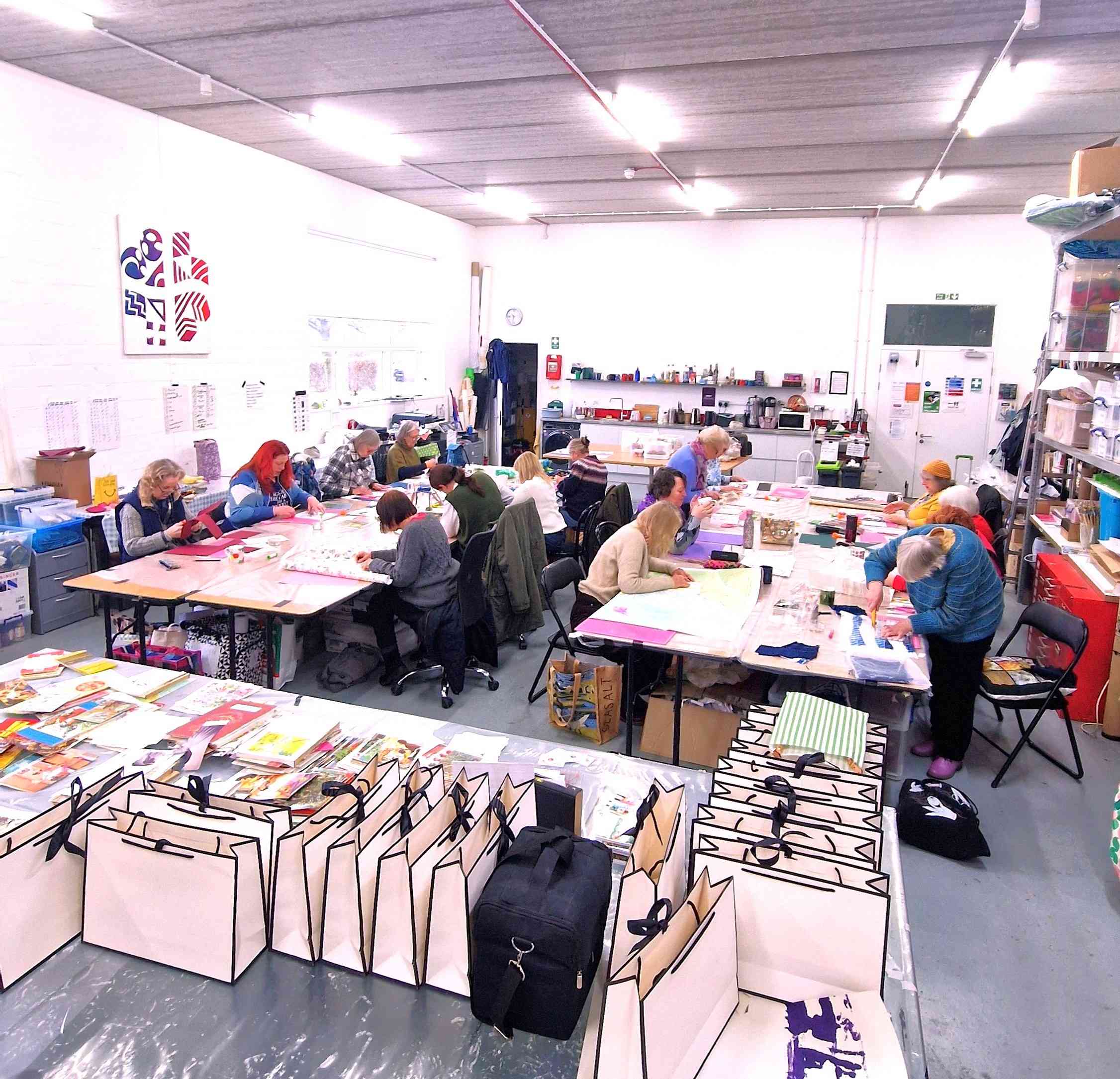 Large group taking part in a creative paper craft workshop in Essex
