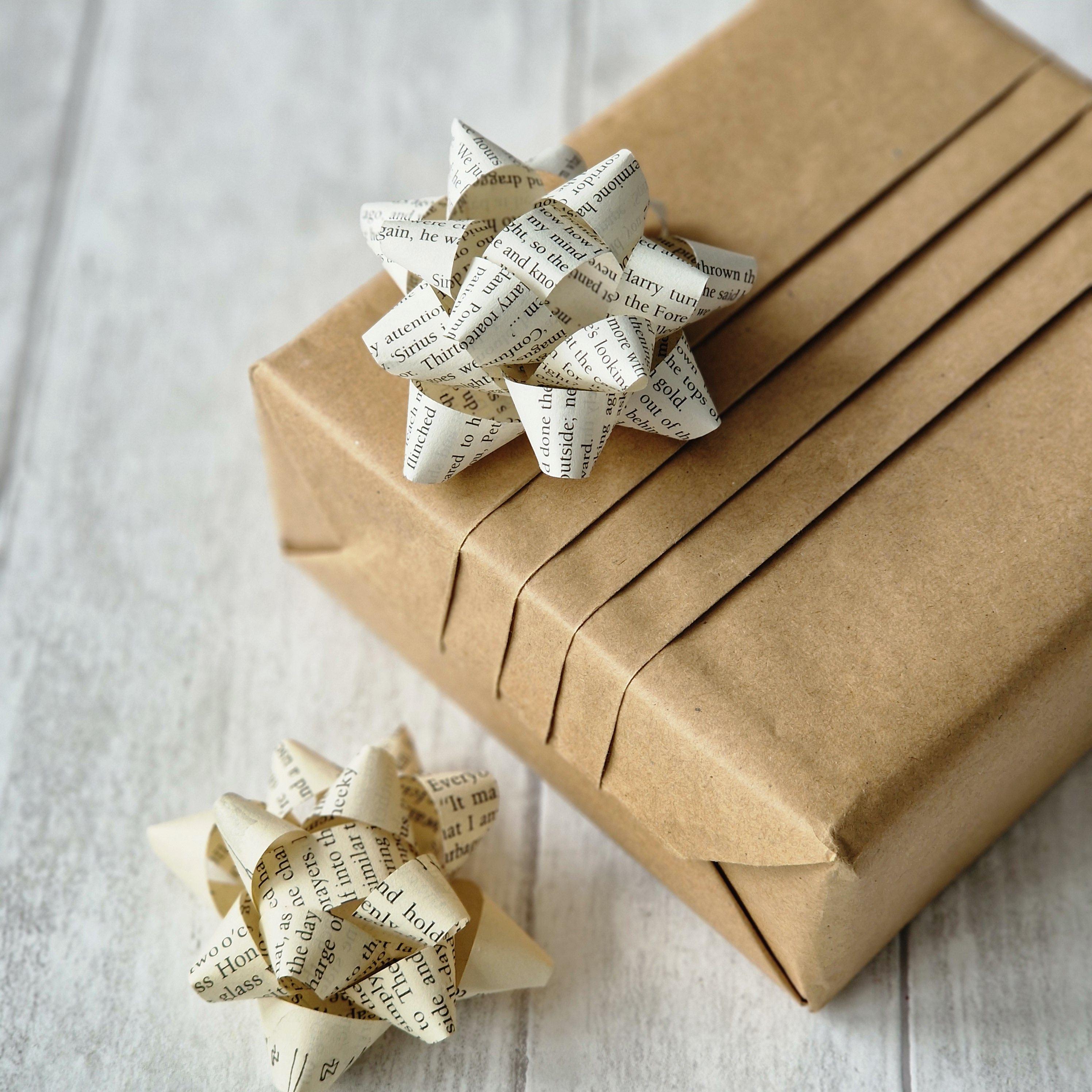 Christmas cards, gift wrap and bows made from recycled book paper