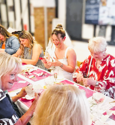 Bride-to-be making book paper roses at a private hen party workshop