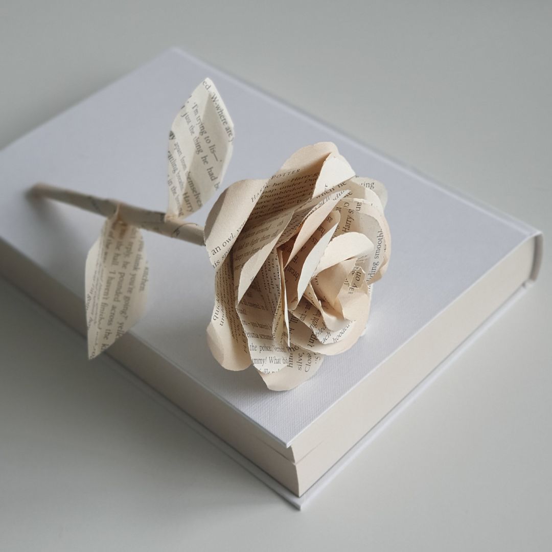 Paper roses made from recycled book pages at a craft workshop