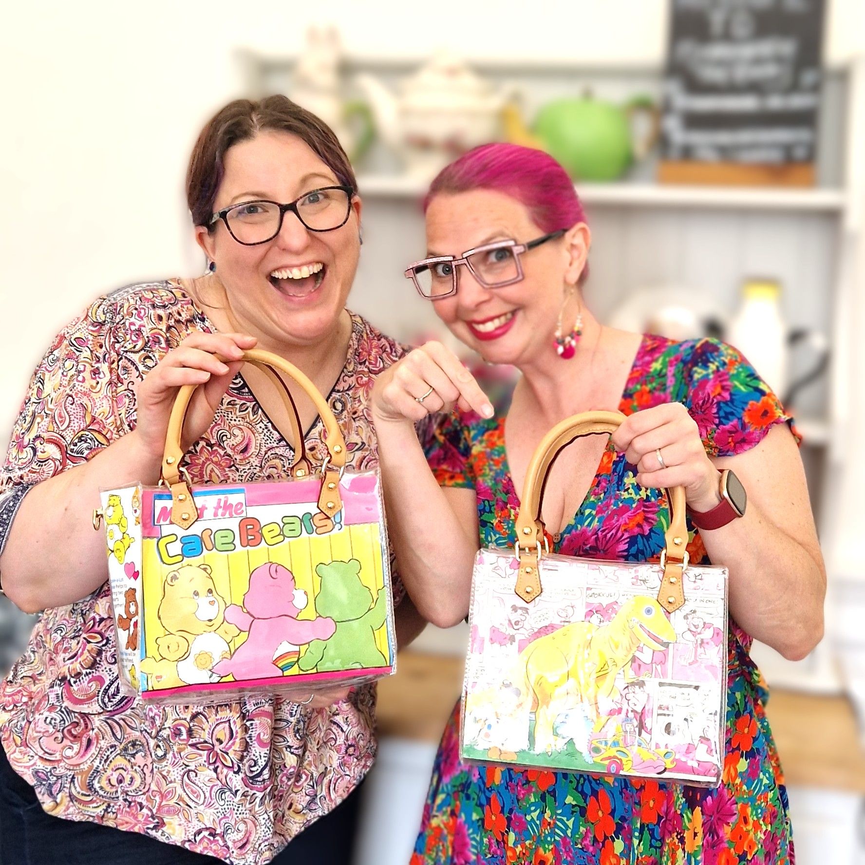 Two participants displaying handbags made from nostalgic book paper